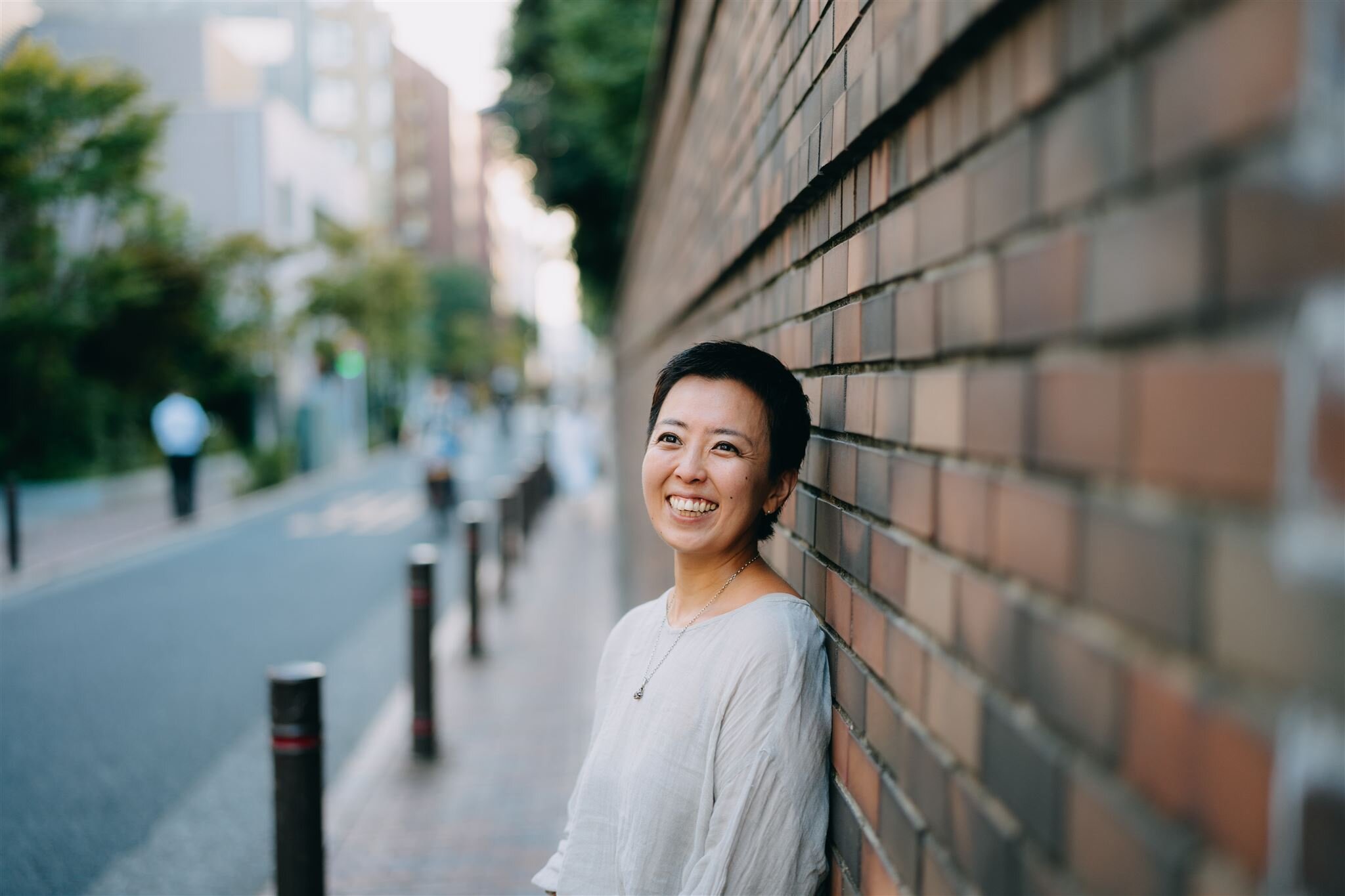 Woman with hazel eyes peeking through grass